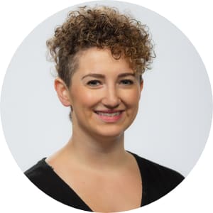 Curly haired brunette headshot on white background.